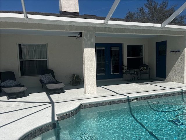 pool with a patio area, french doors, and a lanai