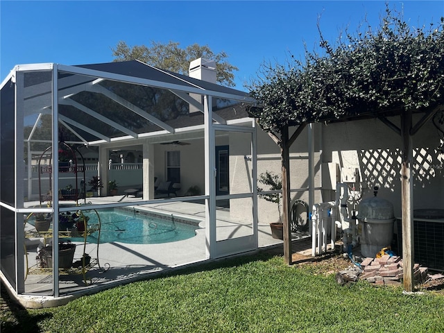 outdoor pool with a patio, a lanai, central AC, and ceiling fan