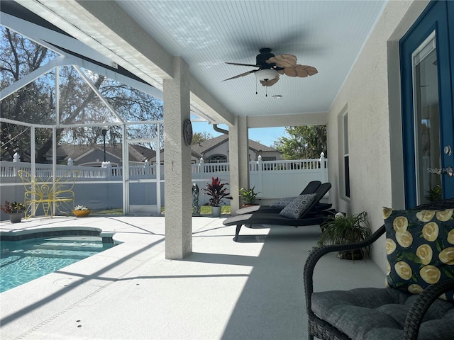 view of pool with a fenced in pool, fence, ceiling fan, a lanai, and a patio area