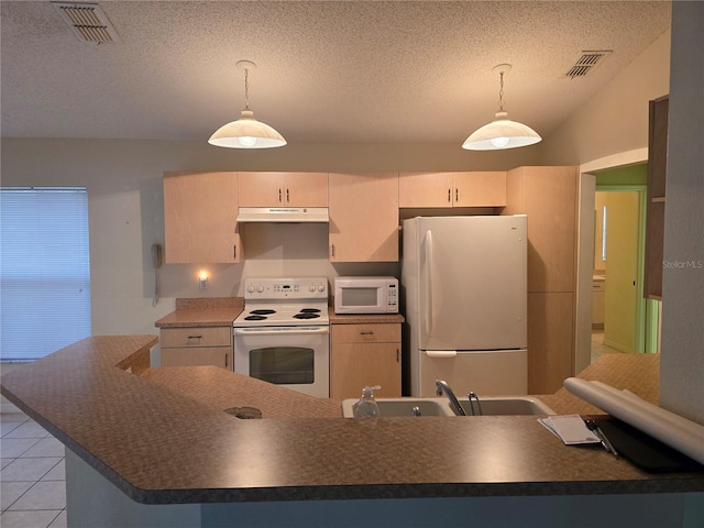 kitchen with white appliances, dark countertops, visible vents, and under cabinet range hood