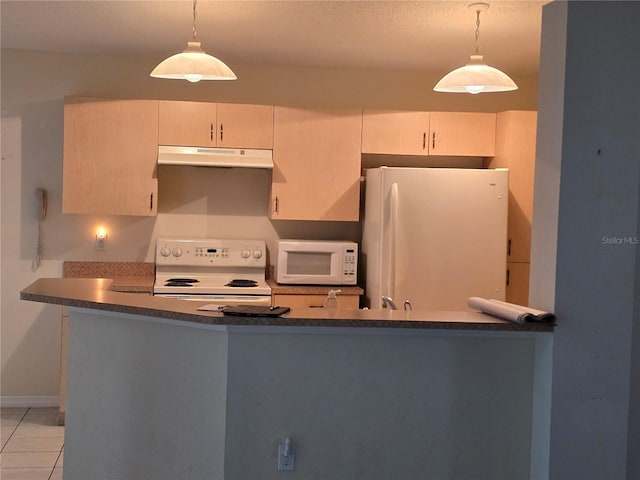 kitchen featuring white appliances, light tile patterned floors, under cabinet range hood, dark countertops, and decorative light fixtures