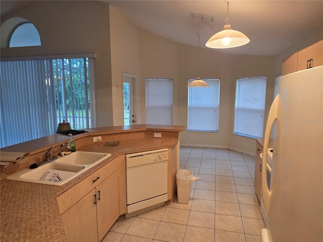 kitchen with a sink, white appliances, light tile patterned flooring, vaulted ceiling, and hanging light fixtures