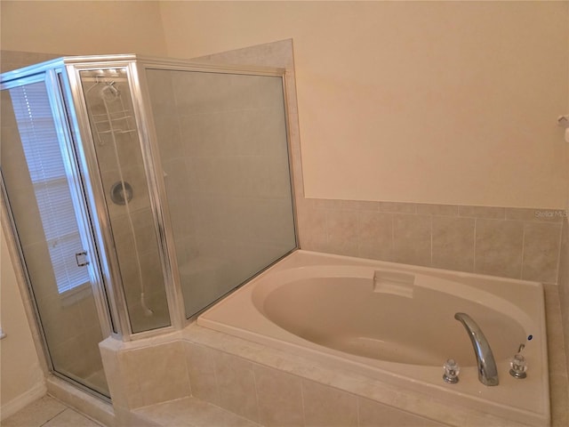 full bath with tile patterned floors, a garden tub, and a stall shower