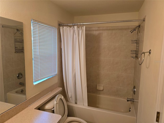 bathroom with vanity, shower / bath combination with curtain, and toilet