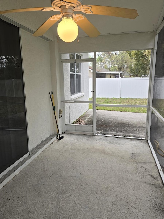 unfurnished sunroom featuring plenty of natural light and ceiling fan