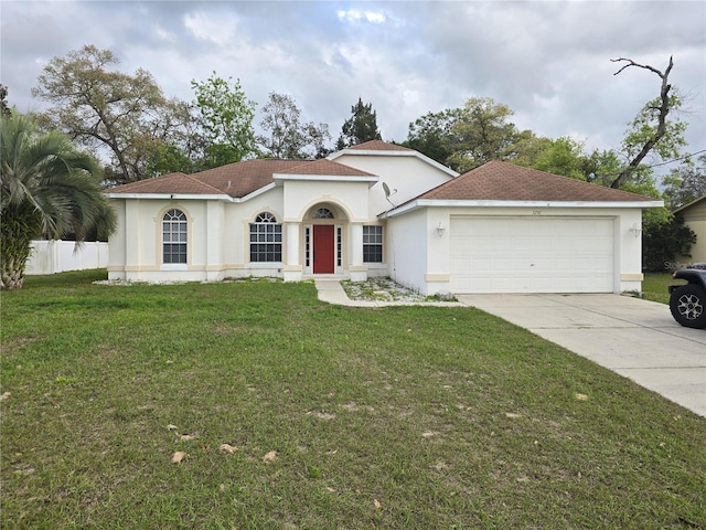 mediterranean / spanish-style house featuring concrete driveway, fence, a front lawn, and stucco siding