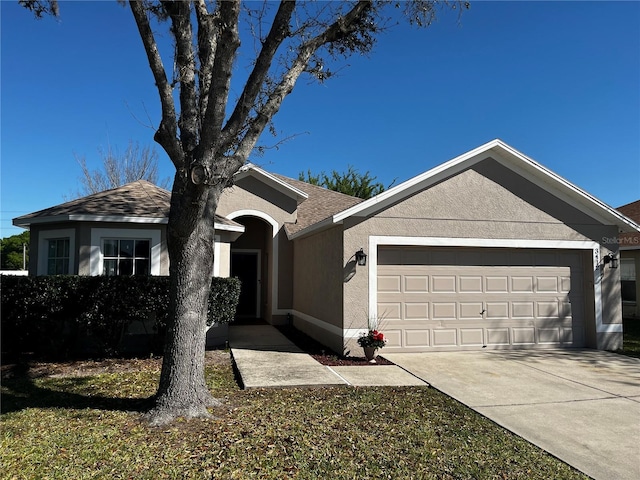 single story home with stucco siding, driveway, a shingled roof, and a garage