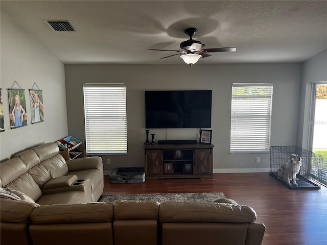 living room with a ceiling fan, wood finished floors, and baseboards