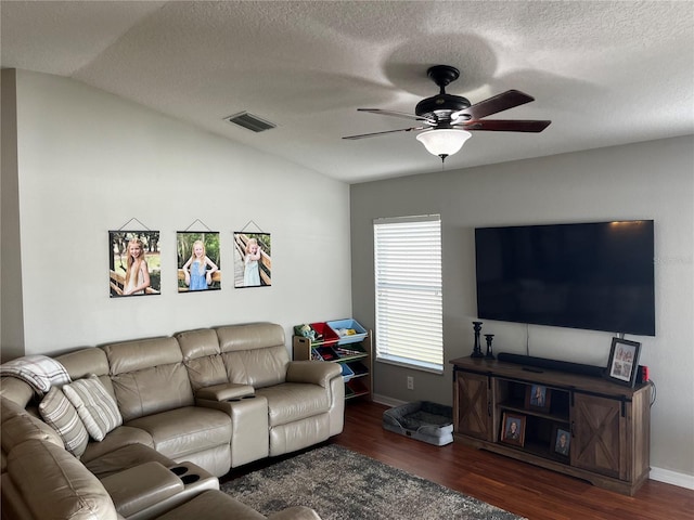 living room with a ceiling fan, wood finished floors, visible vents, lofted ceiling, and a textured ceiling