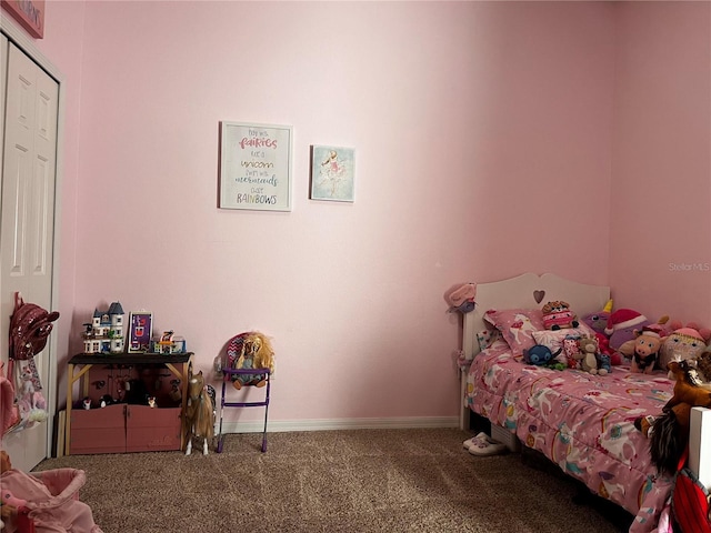 bedroom with baseboards and carpet floors