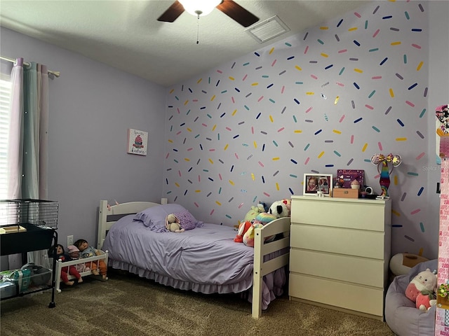 bedroom with lofted ceiling, carpet, visible vents, and ceiling fan