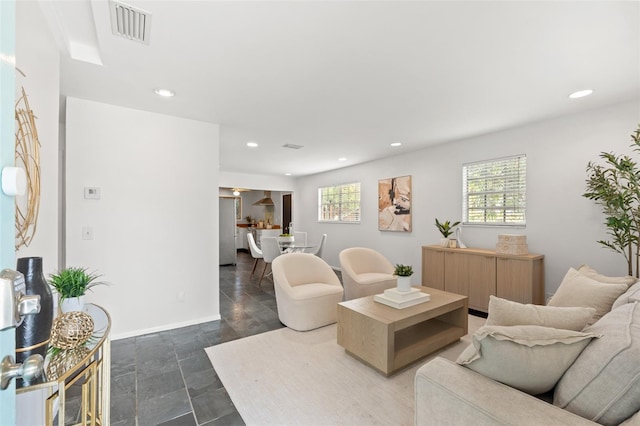 living room featuring recessed lighting, visible vents, and a wealth of natural light