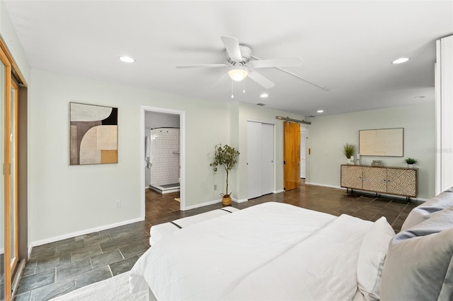 bedroom featuring a barn door, recessed lighting, ensuite bath, and baseboards