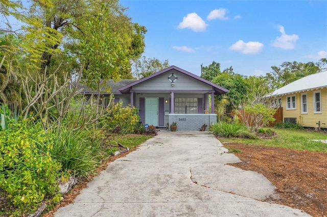 view of front of property featuring a porch and concrete driveway