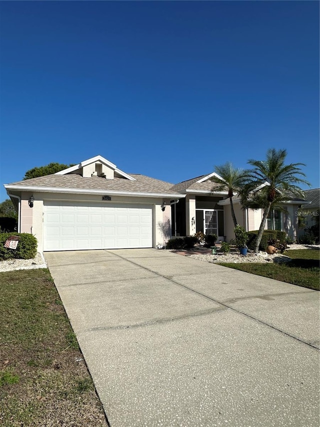 view of front of house featuring a garage, driveway, and stucco siding