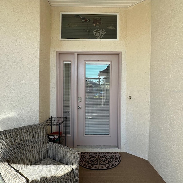 property entrance featuring stucco siding