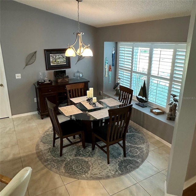 dining room with baseboards, vaulted ceiling, light tile patterned floors, an inviting chandelier, and a textured ceiling