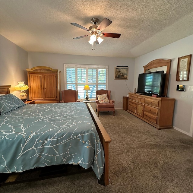 carpeted bedroom featuring baseboards, a textured ceiling, and a ceiling fan