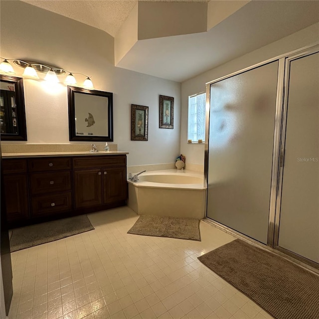 full bath featuring a garden tub, a stall shower, vanity, and a textured ceiling