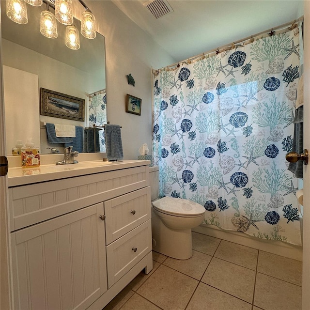 bathroom featuring visible vents, toilet, vanity, and tile patterned flooring