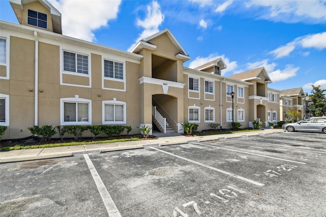 view of property featuring a residential view and uncovered parking