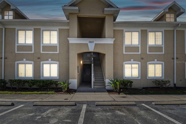 property at dusk with uncovered parking