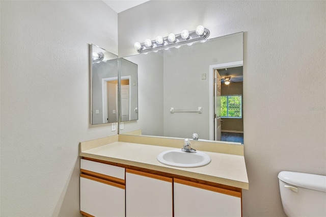 half bathroom with toilet and vanity