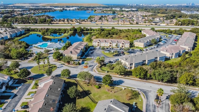 drone / aerial view featuring a water view and a residential view