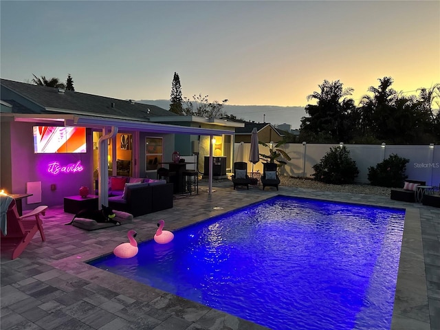 view of swimming pool with an outdoor living space, a fenced in pool, fence private yard, and a patio area