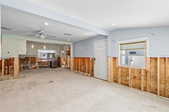 miscellaneous room featuring wooden walls, visible vents, wainscoting, and ceiling fan