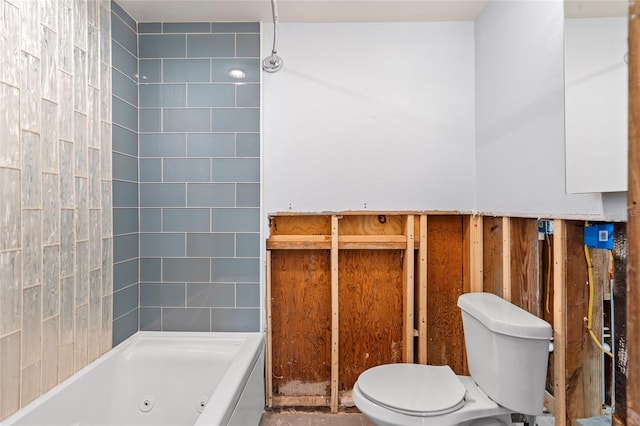 bathroom featuring toilet and a combined bath / shower with jetted tub