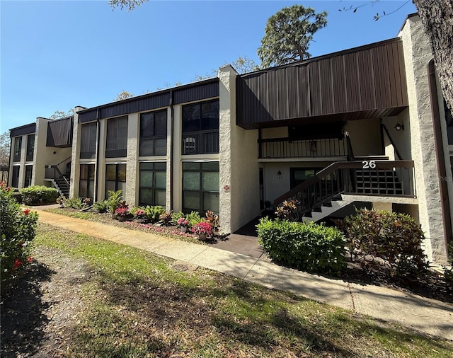 view of property featuring stairs