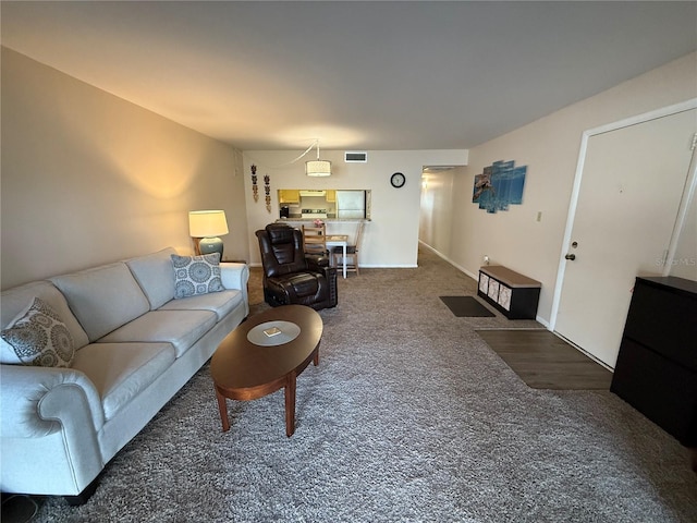 carpeted living room featuring baseboards and visible vents