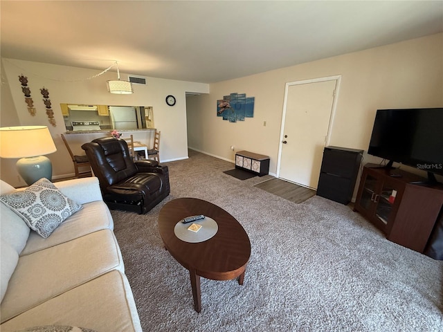 carpeted living room with visible vents and baseboards