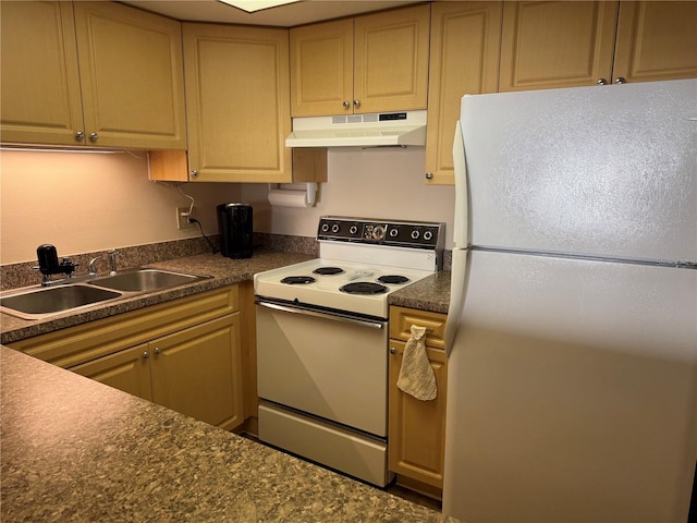 kitchen with white appliances, dark countertops, under cabinet range hood, and a sink