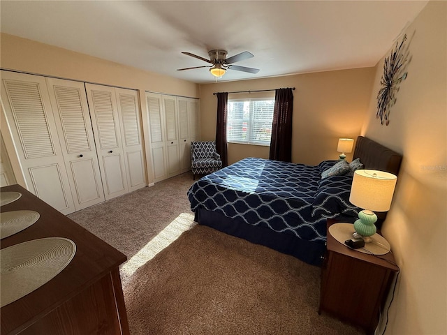 bedroom featuring multiple closets, carpet floors, and a ceiling fan