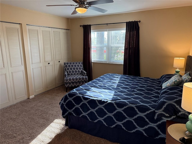 bedroom featuring ceiling fan, carpet, and multiple closets