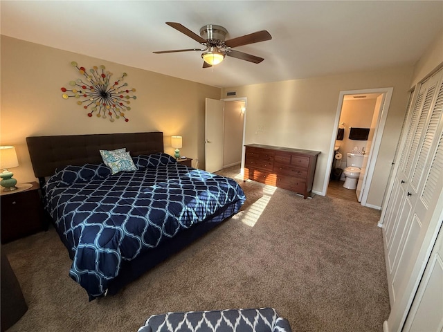 carpeted bedroom featuring baseboards, visible vents, ceiling fan, a closet, and ensuite bathroom