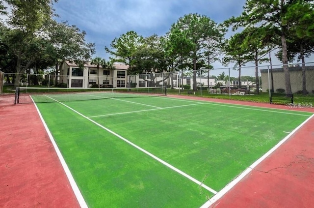 view of sport court featuring fence