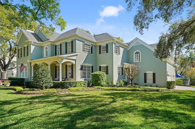 view of front of property featuring a front lawn and stucco siding