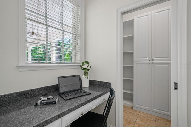 office area featuring light tile patterned flooring and built in study area