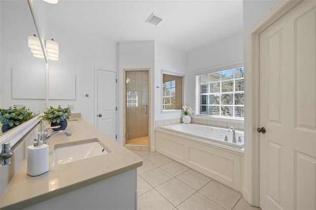 bathroom featuring visible vents, a sink, tile patterned flooring, a shower stall, and a bath