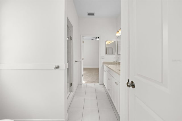 bathroom featuring tile patterned floors, visible vents, a stall shower, baseboards, and vanity