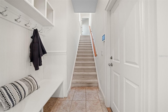 mudroom with a wainscoted wall and light tile patterned flooring