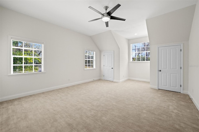 unfurnished bedroom with lofted ceiling, light colored carpet, baseboards, and ceiling fan