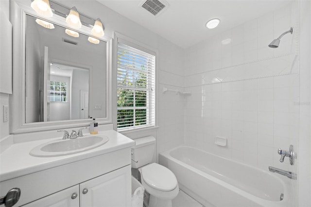 bathroom featuring washtub / shower combination, visible vents, toilet, and vanity