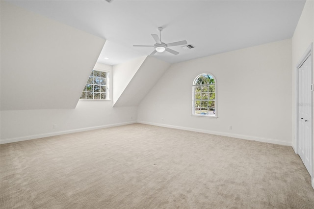 bonus room featuring baseboards, visible vents, carpet floors, and a healthy amount of sunlight