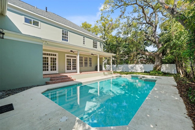 view of swimming pool featuring a fenced in pool, ceiling fan, fence, french doors, and a patio