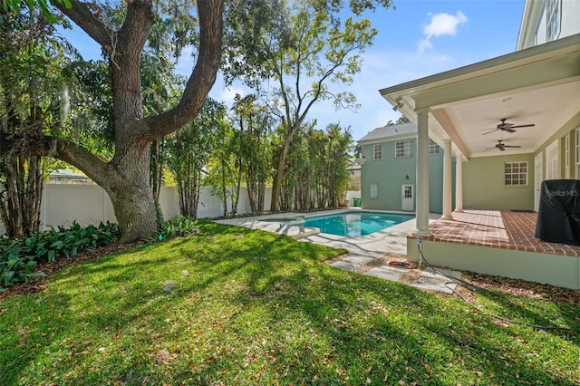 view of swimming pool featuring a fenced in pool, ceiling fan, a yard, a fenced backyard, and a patio area