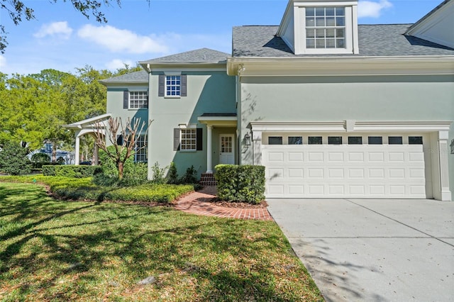 view of front of house featuring stucco siding, concrete driveway, a garage, and a front yard